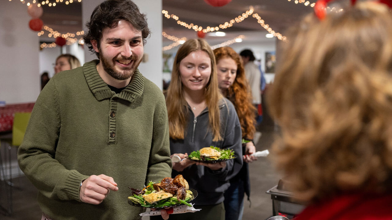 Students line up to get their holiday meal in the North Haven Cafe