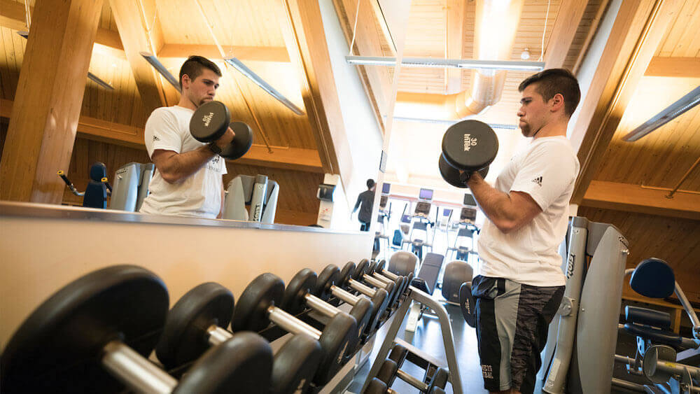 Emilio Zullo working out in the weightlifting gym in the Rocky Top Student Center, on the York Hill Campus.