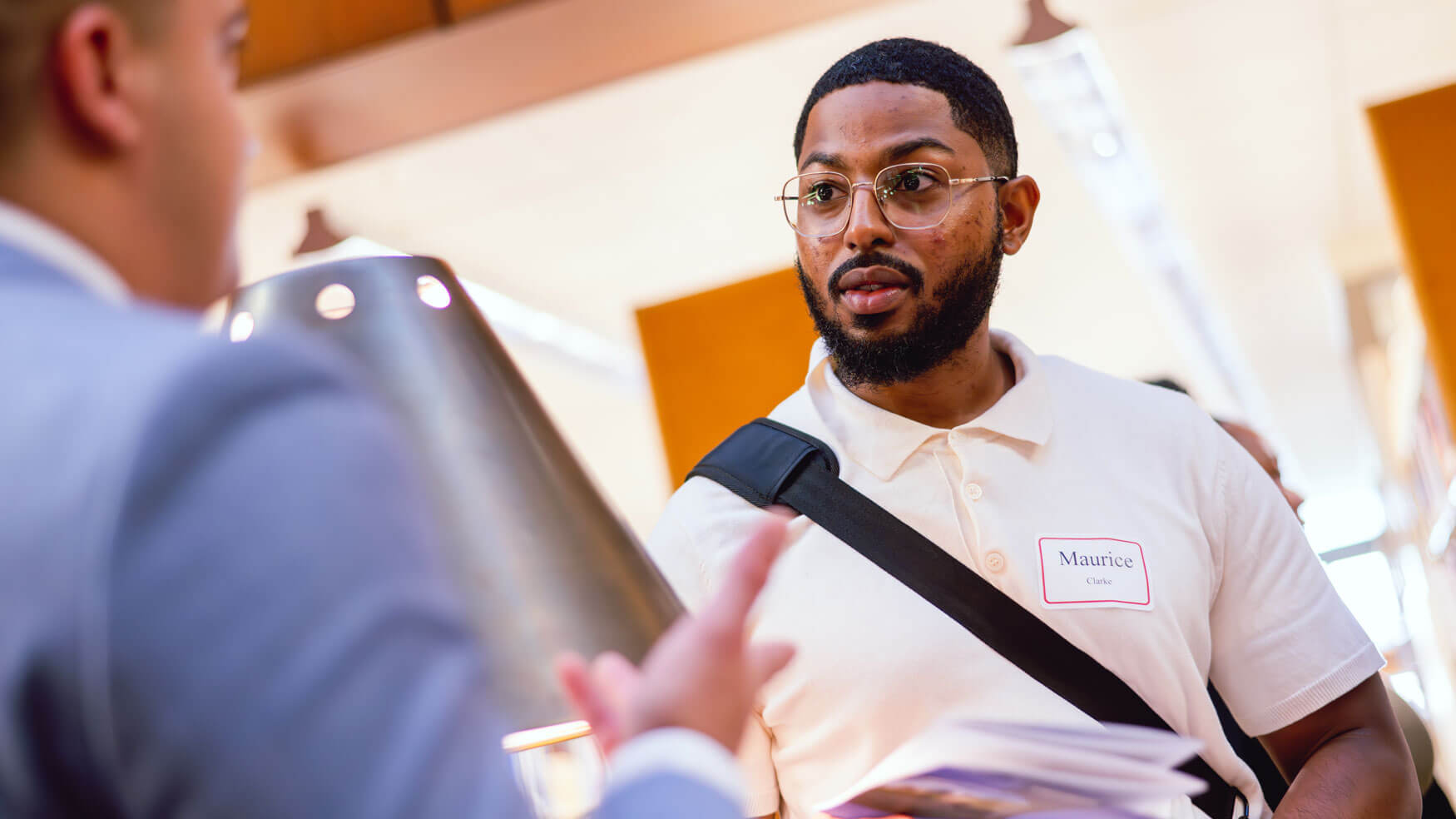 A law student talks with a representative at the law fair.