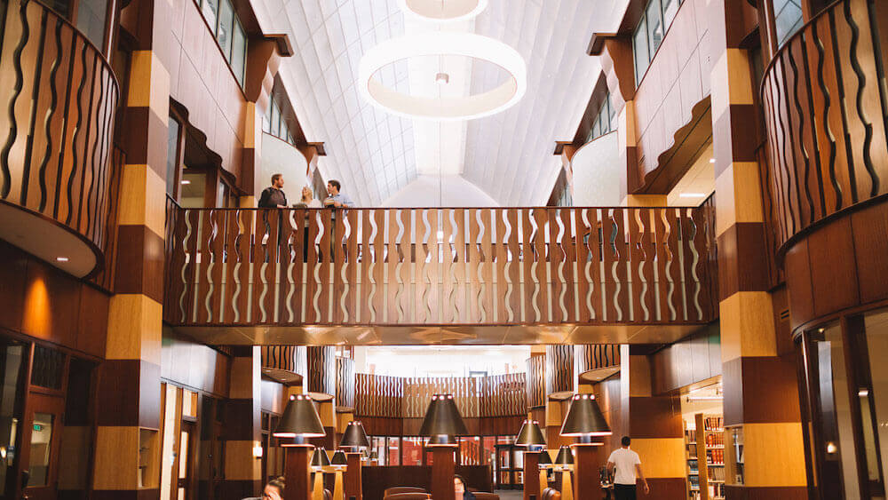 Students talk on the walkway above the Lynne L. Pantalena Law Library